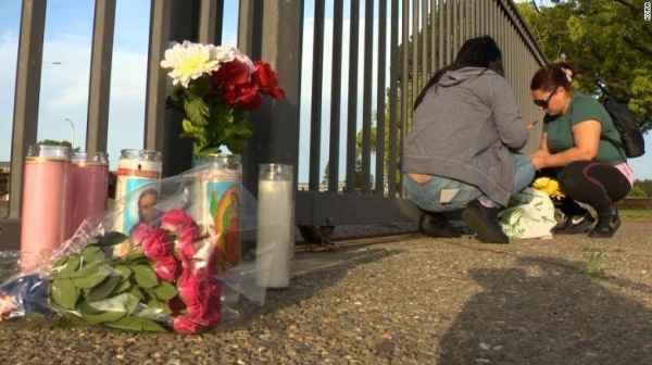 Mourners gather at a memorial for a Stockton, California, high school student who was fatally stabbed Monday.