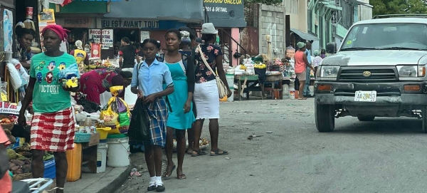 A crowded sidewalk with various items for sale in a Port-au-Prince neighborhood. The multipronged crisis has a “decidedly female face
