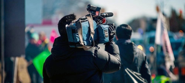 A video journalist covers a news event. — courtesy Unsplash/Jovaughn Stephens