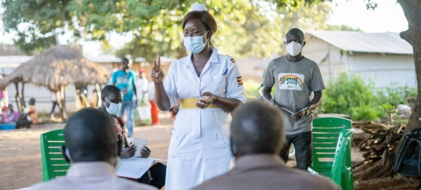 Judith Candiru, an Assistant Nursing Officer in Yumbe district Uganda, provides COVID-19 vaccination services within the community of Midigo. — courtesy UNICEF/Zahara Abdul
