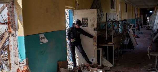 The principal of a school in Chernihiv, Ukraine, surveys the damage caused during an aerial bombardment.