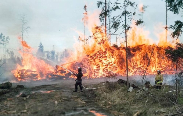 Firefights battle raging wildfires that have broken out across southwestern Siberia in Russia have killed at least 10 people and damaged hundreds of buildings this week. 