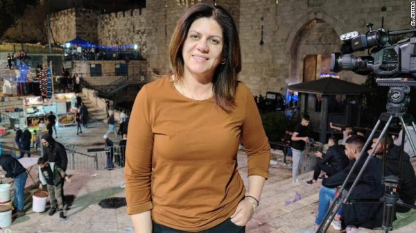 Mourners, including journalists, react next to the body of Al Jazeera reporter Shireen Abu Akleh.
