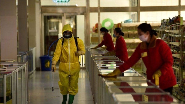 Employees spray disinfectant and wipe surfaces in North Korea's capital, Pyongyang.