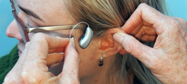 A woman being fitted for a receiver-in-canal (RIC) hearing aid. — courtesy Unsplash/Mark Paton