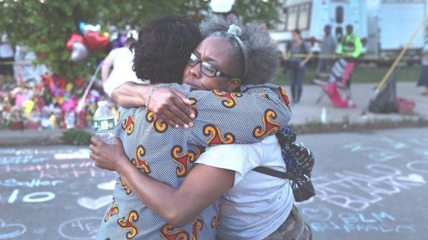 Zaire Goodman, left, with his mother. Goodman was shot in the neck but miraculously survived.