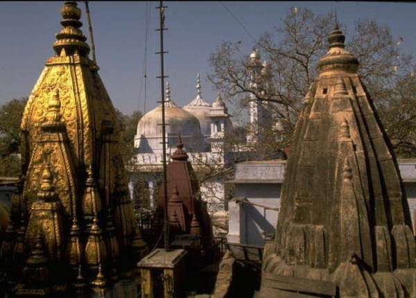 The golden top of the Vishwanath temple is framed by the Gyanvapi mosque in Varanasi.