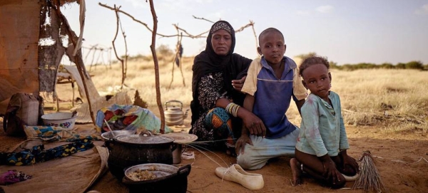 A displaced family sit in front of their tent at an informal camp in Bagoundié in Mali. — courtesy UNOCHA/Michele Cattani