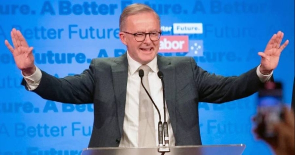 Anthony Albanese acknowledges the applause after being elected as Australia's prime minister, ousting Scott Morrison's coalition.