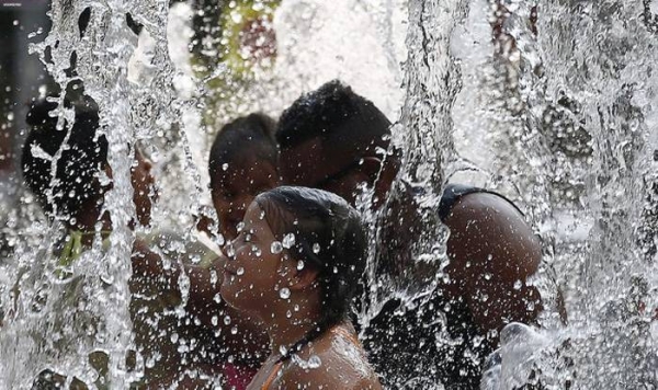 Children frolick in a public fountain in Barcelona, Spain, as a heatwave sweeps the country. — courtesy Twitter