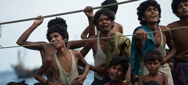 Stranded Rohingya boat people, desperate for food and water, sit on the deck of an abandoned smugglers' boat drifting in Thai waters off the southern island of Koh Lipe in the Andaman sea. (file)