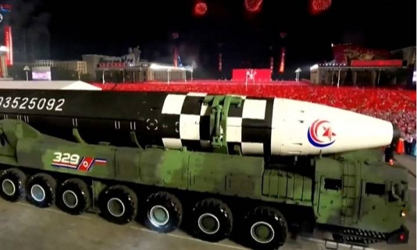 North Korea showcases banned missiles in a military parade broadcast on state TV.