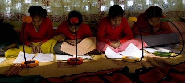 In India, village schools lacking electricity are being provided with solar lamps to help students study.