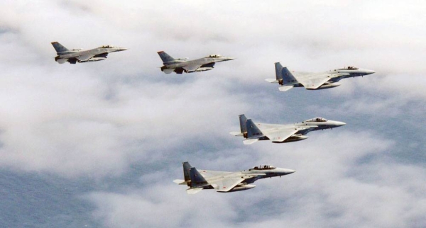 Photo taken on Tuesday, shows three F-15 fighter jets (front) of the Japanese Air Self-Defense Force and two F-16s of the US Air Force during a joint drill. — courtesy Kyodo