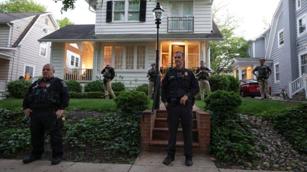 Police stand outside the home of US Associate Justice Brett Kavanaugh as abortion-rights advocates protest on May 11, 2022 in Chevy Chase, Maryland.
