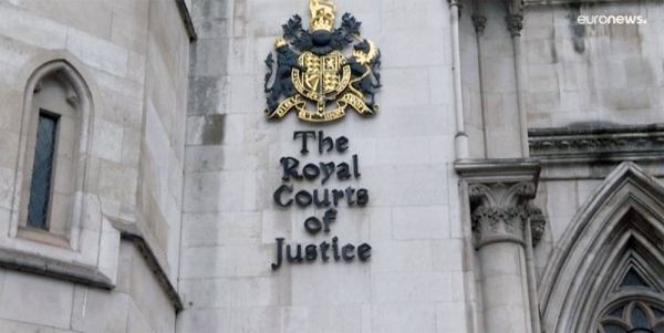 Protestors stand outside The Royal Court of Justice in London. Several NGOs lost a challenge opposing the Home Office's new asylum deal with Rwanda.