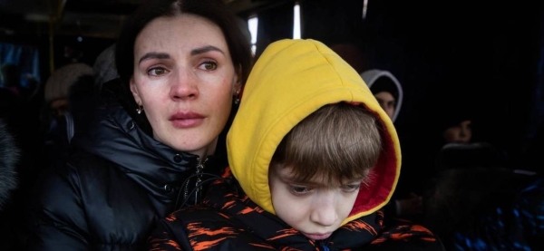 A mother and her son wait to be evacuated from the besieged city of Mikolayiv in Ukraine in March 2022.
