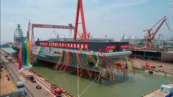 China celebrates the launch of its third aircraft carrier, at a dry dock in Shanghai on Friday.