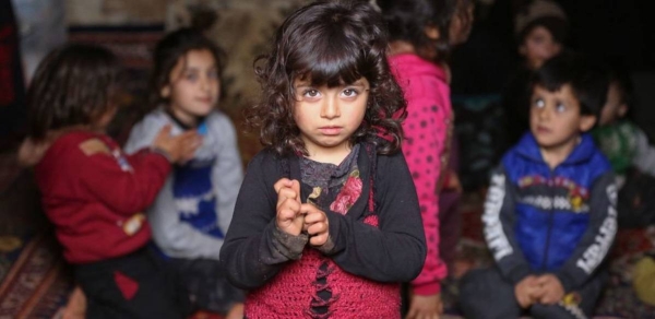 A displaced girl stands among other children inside an underground cave where families were sheltering in Taltouna village, in the northwestern city of Idlib, Syria (file photo).