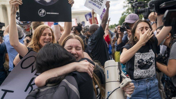 Anti-abortion activists celebrate the announcement outside the Supreme Court.