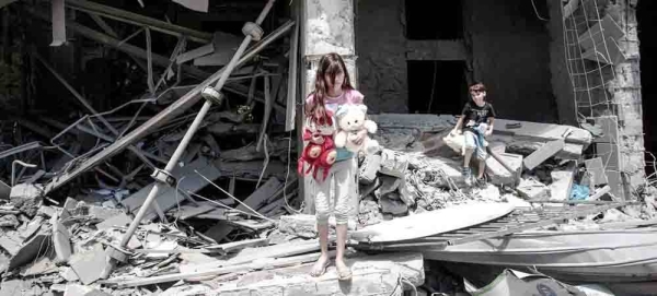 A Palestinian girl and boy salvage items from inside their damaged home in Gaza City. — courtesy UNICEF/Eyad El Baba