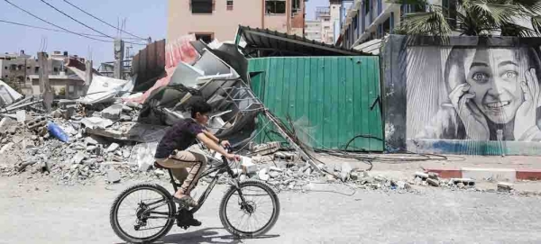 A Palestinian girl and boy salvage items from inside their damaged home in Gaza City. — courtesy UNICEF/Eyad El Baba