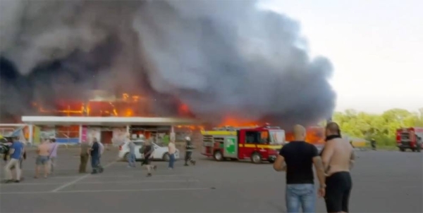A shopping center burned after a rocket attack in which dozens of people are feared killed and injured, Kremenchuk, Ukraine, Tuesday.