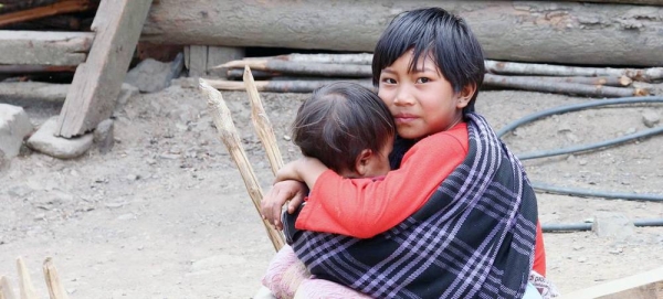 A child looks after his younger sibling in Myanmar. — courtesy World Bank/Tom Cheatham