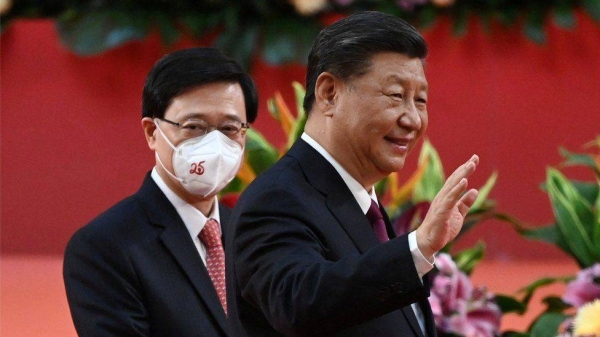 Chinese President Xi Jinping walks with Hong Kong chief executive John Lee behind following his speech at a ceremony to inaugurate the city's new leader and government on Friday.