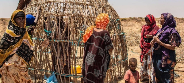 A family in the Somali region of Ethiopia build a temporary shelter after fleeing their home.