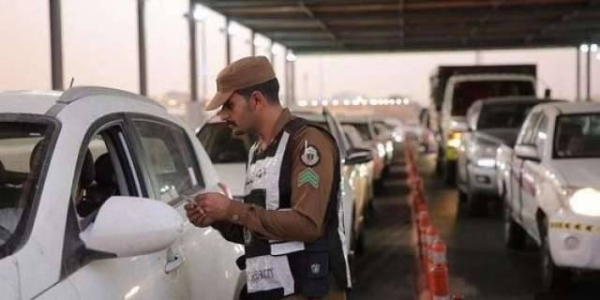 Traffic policemen check permits for entering Makkah at one of the checkpoints to the holy city.