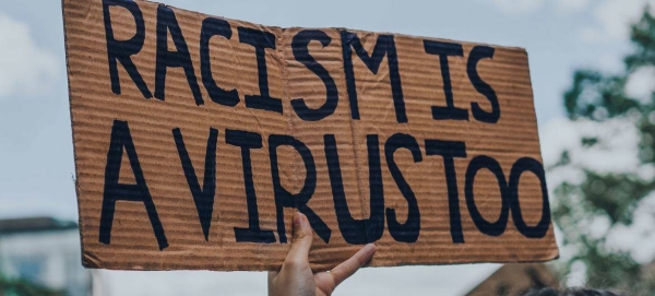 'Racism is a Virus' sign at a Black Lives Matter protest in Montreal, Canada.