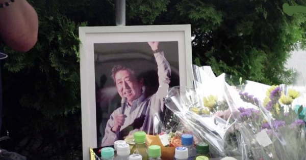 People pray at a makeshift memorial for the former Prime Minister Shinzo Abe, who was shot in Nara, western Japan Saturday.