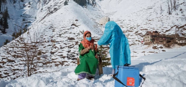 A healthcare worker from a clinic in North Kashmir braves freezing temperatures and snow to vaccinate people living in remote areas of India. jpg