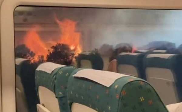 A train is surrounded by wildfires in Spain.