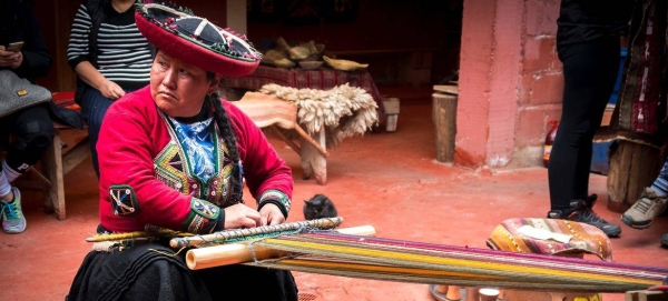 A woman weaving in the streets of Chinchero district, Peru