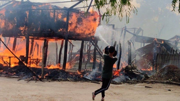 A man tries to put out a fire.