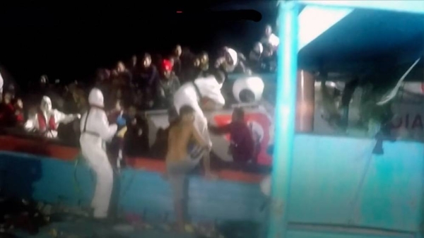 A migrant is being rescued from the sea. Nearly 1,200 undocumented migrants have arrived in Italy over the past 24 hours, authorities say.