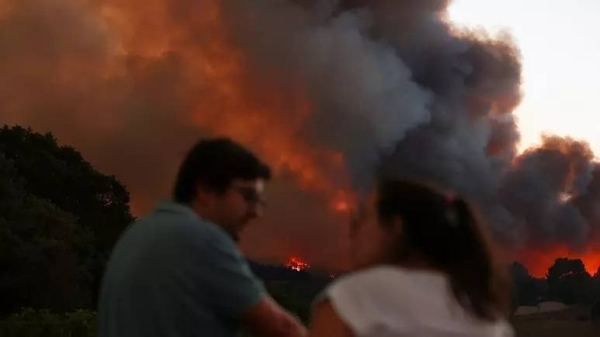 Smoke rises from a wildfire in Venda do Pinheiro in Mafra, Portugal, on July 31