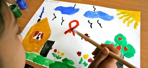 A nine-year-old girl, who is HIV-positive, paints at a UNICEF-supported day care centre which provides psychosocial care in Tashkent, Uzbekistan.