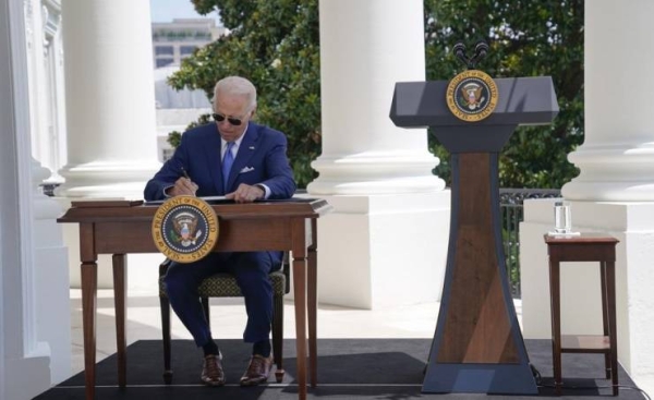 Still isolating, Biden signs anti-fraud pandemic bills