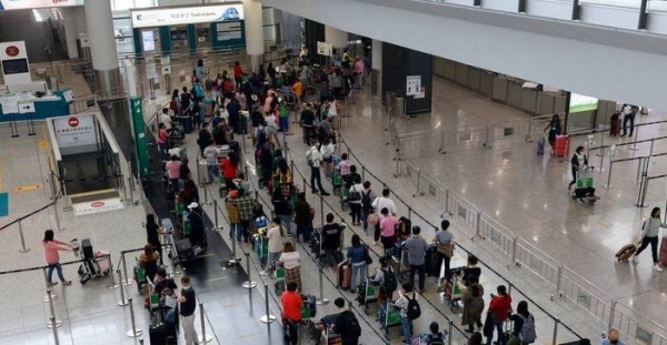 Travelers at Hong Kong International Airport.