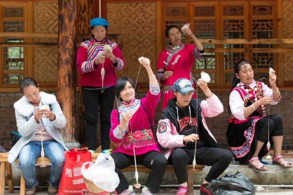 Tearing wool thread in Lijiang as part of training in traditional weaving