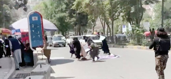 Taliban fighters fire in air to disperse Afghan women protesters in Kabul on Saturday.