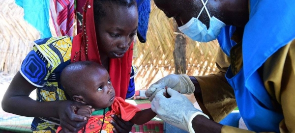 A baby is tested for malaria at a community health centre in Chad.