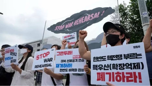 Protesters stage a rally to oppose the joint military exercises between the US and South Korea in front of the presidential office in Seoul on Monday.