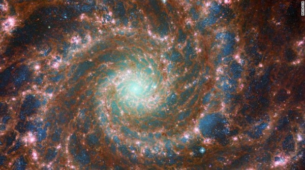 M74 shines at its brightest in this combined optical mid-infrared image, featuring data from both the Hubble Space Telescope and th.e James Webb Space Telescope. 