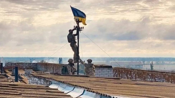 Ukraine says this shows its soldiers hoisting the flag over Vysokopillya, in the Kherson region, on Sunday.
