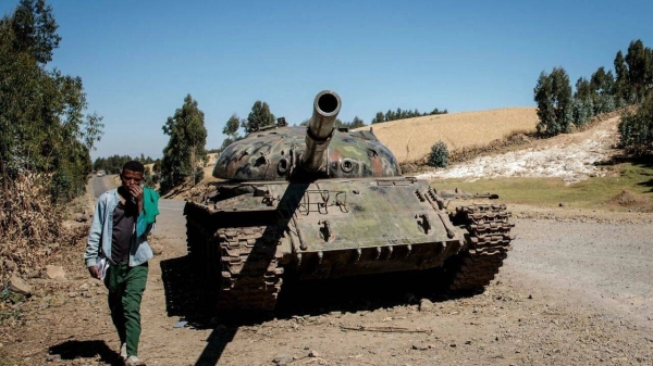 A man walks past a tank said to have belonged to Tigray People's Liberation Front (TPLF) rebels near Debre Tabor, on December 6, 2021. (file)