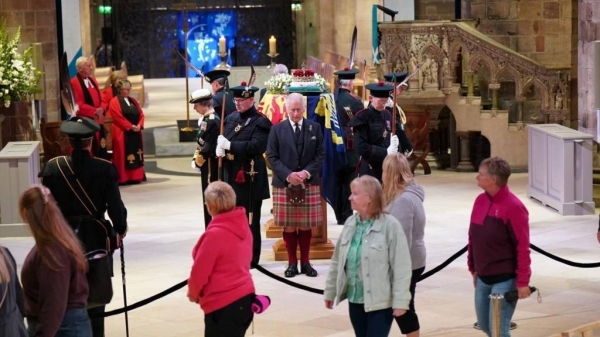 Mourners file past the coffin as the Queen's four children kept a traditional vigil as she lay at rest at St Giles' Cathedral in Edinburgh, Scotland.